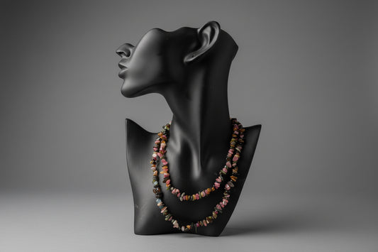 Black mannequin head with colorful Mixed_Color_Tourmaline_Necklace_30-32_Inches beads on a stand in gray studio.