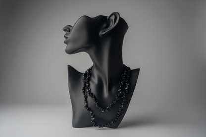 Black mixed obsidian chip beaded necklace on a black mannequin bust against a gray background