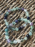 Multicolored beaded bracelets on a woven surface