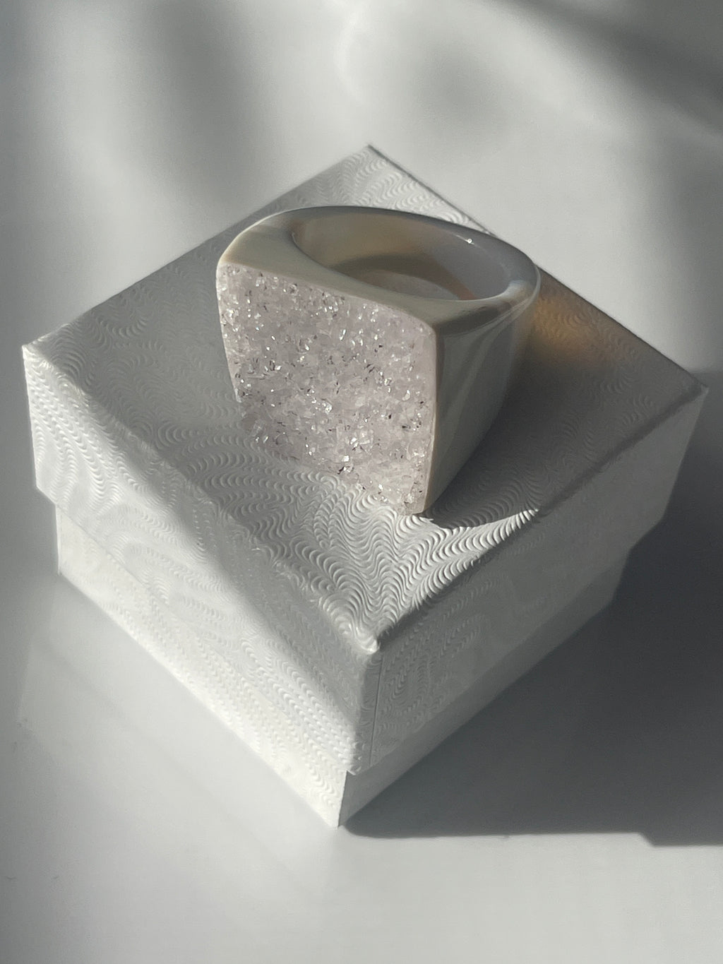 Close-up of a metallic hexagonal object with intricate patterns on a reflective surface ... Natural Agate Druzy Ring Pure Energy Crystals Florida