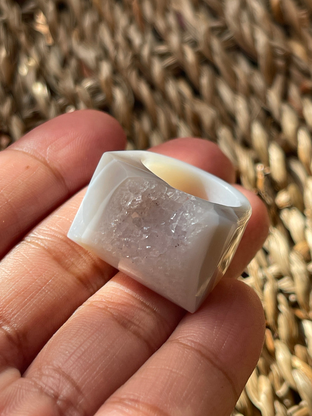 Clear crystal held in a hand against a woven background Natural Agate Druzy Ring Pure Energy Crystals Florida