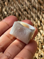Clear crystal held in a hand against a woven background Natural Agate Druzy Ring Pure Energy Crystals Florida