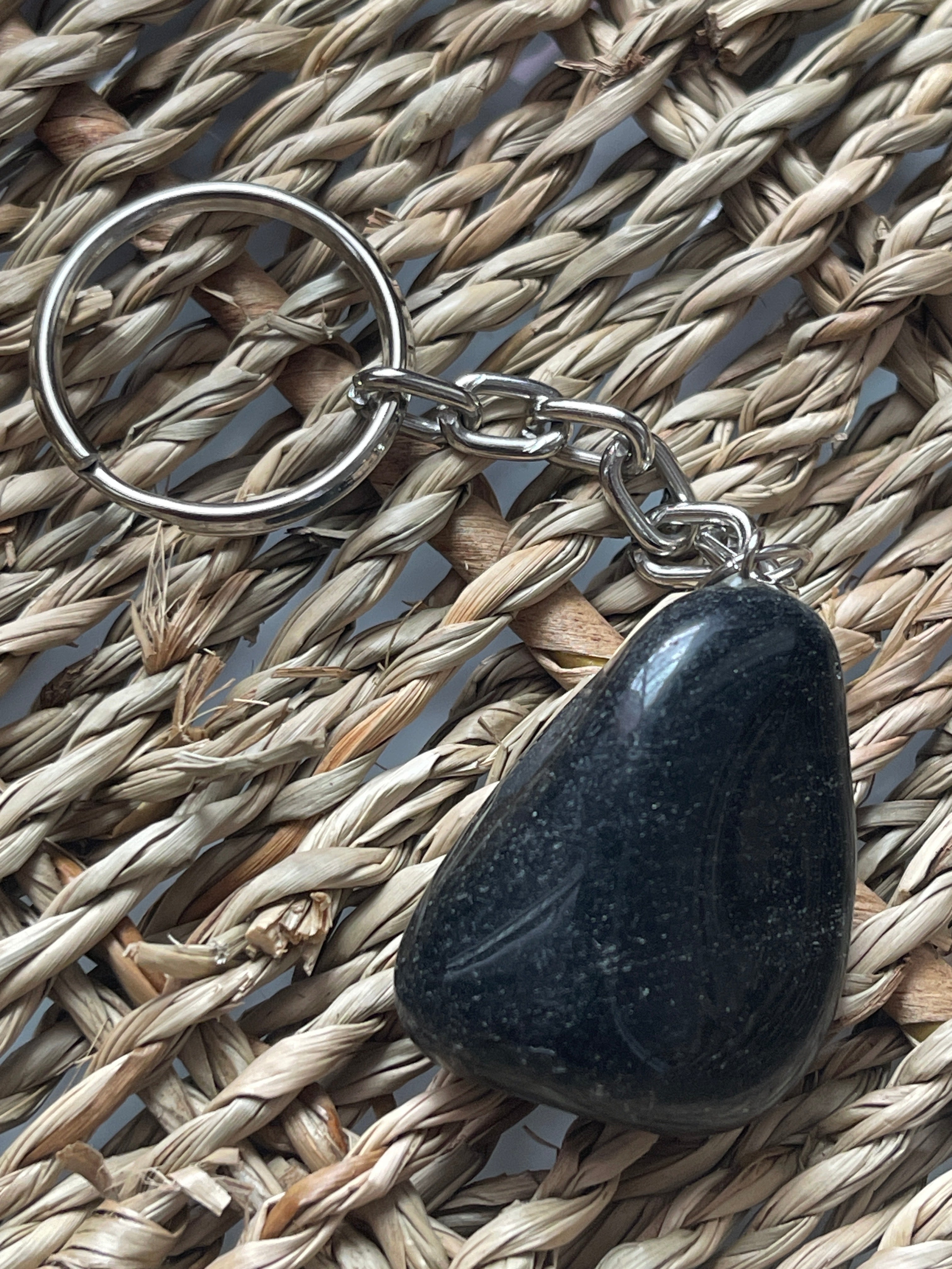 Obsidian Black stone keychain on a woven mat