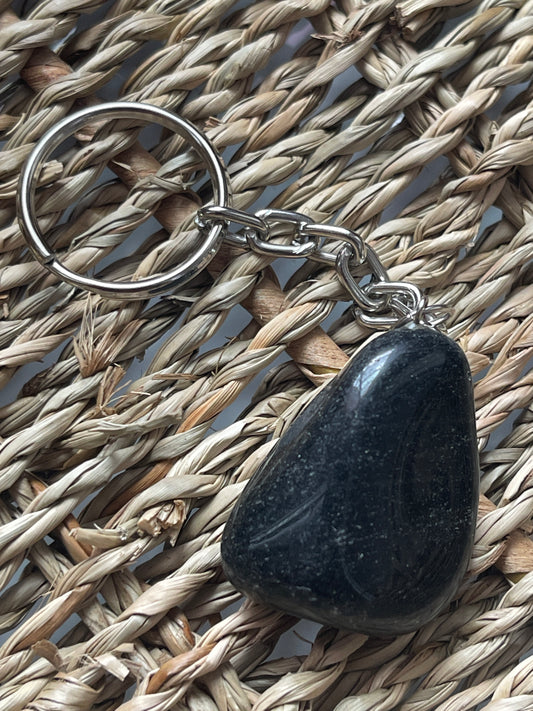 Obsidian Black stone keychain on a woven mat