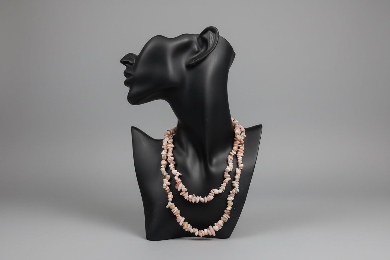 Pink_Opal_Necklace_30-32_Inches on a black jewelry stand with a blurred gray studio background 