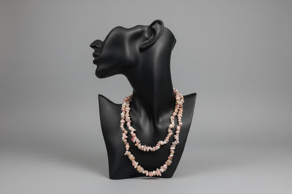 Pink_Opal_Necklace_30-32_Inches on a black jewelry stand with a blurred gray studio background 