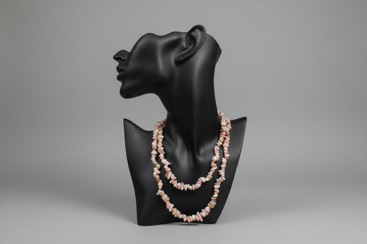 Pink_Opal_Necklace_30-32_Inches on a black jewelry stand with a blurred gray studio background 