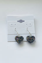 Rainbow Heart Coated Amethyst Earrings, Heart-shaped earrings on a white card with a gray background