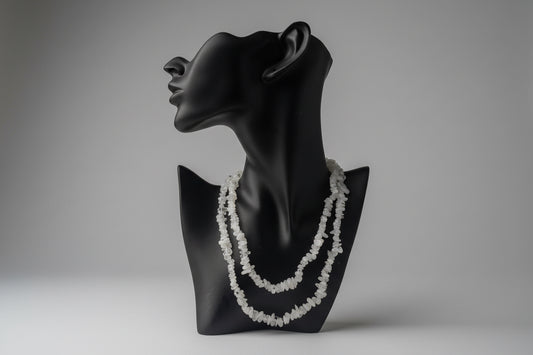  Black necklace display with decorative Rainbow_Moonstone_Necklace_30-32_Inches white stones with a gray backdrop in a studio 