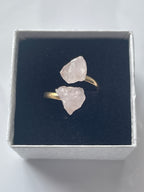 Rose quartz raw gold pink crystal ring in a jewelry box on a light white background