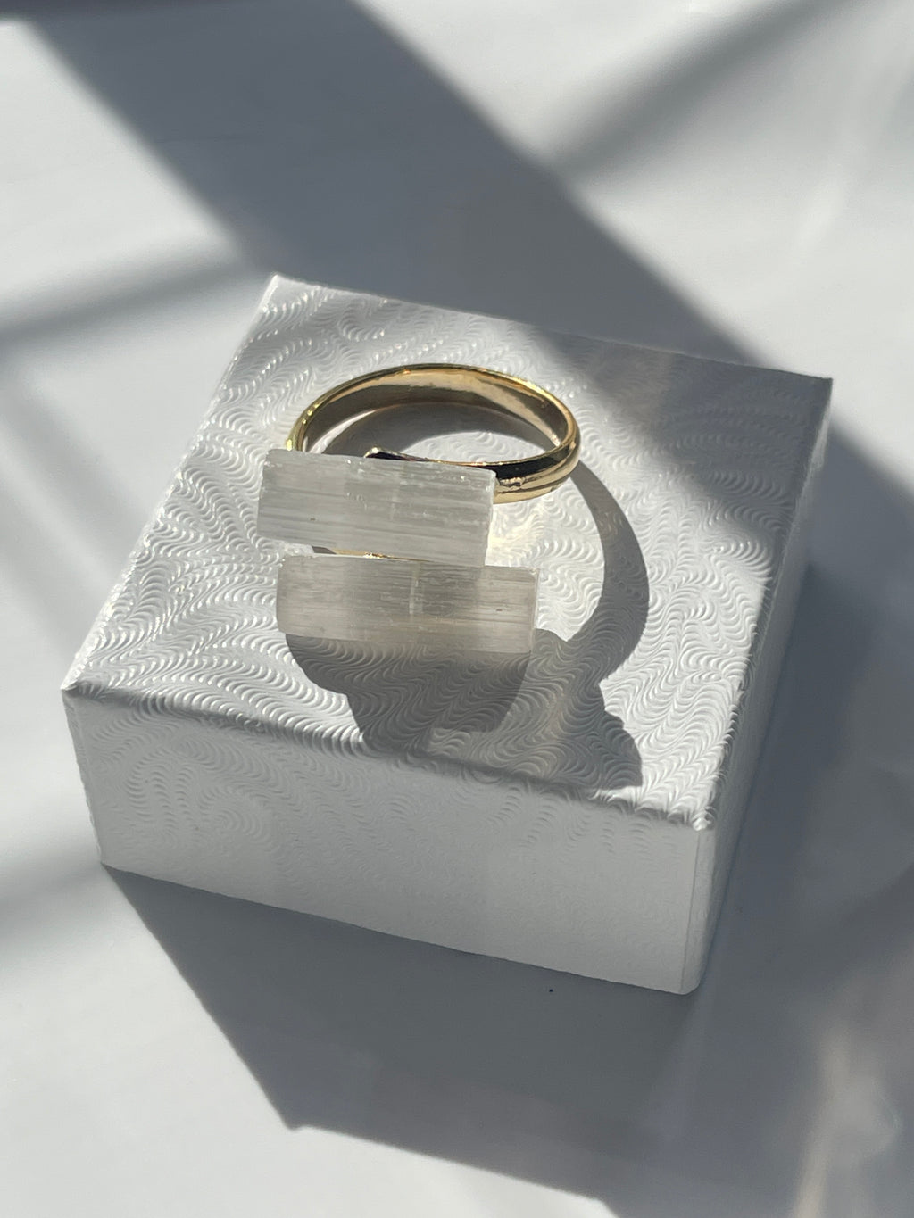Selenite ring from on top of a white box top 