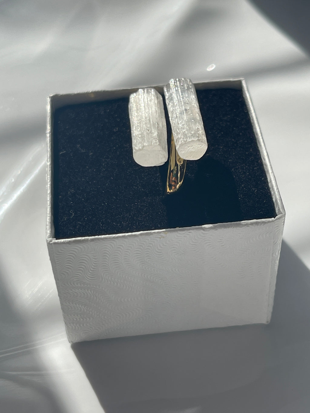 Crystal silver plated selenite ring inside a jewelry box from the side view