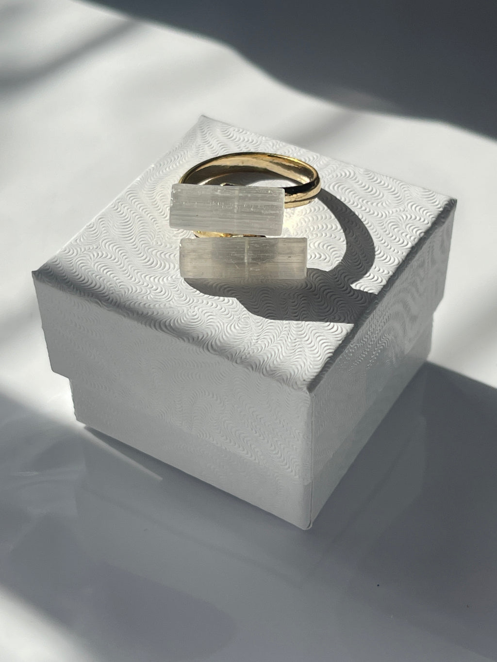 Selenite Gold plated ring on a white jewelry box in Florida