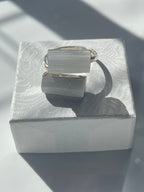 Selenite adjustable silver plated ring in a studio on a box top in Florida