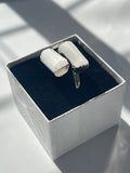 Silver plated selenite ring inside a white and black jewelry box 