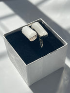 Silver plated selenite ring inside a white and black jewelry box 