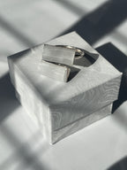 Selenite silver plated adjustable ring on top of a jewelry box