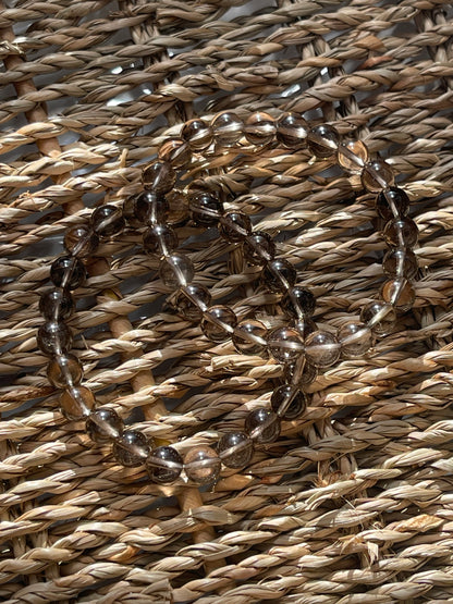 Smoky Quartz Beaded bracelet on a woven straw surface
