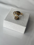 Tigers eye gold plated ring on a textured white jewelry box top in Florida 
