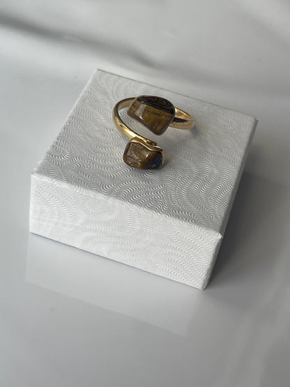 Tigers eye gold plated ring on a textured white jewelry box top in Florida 