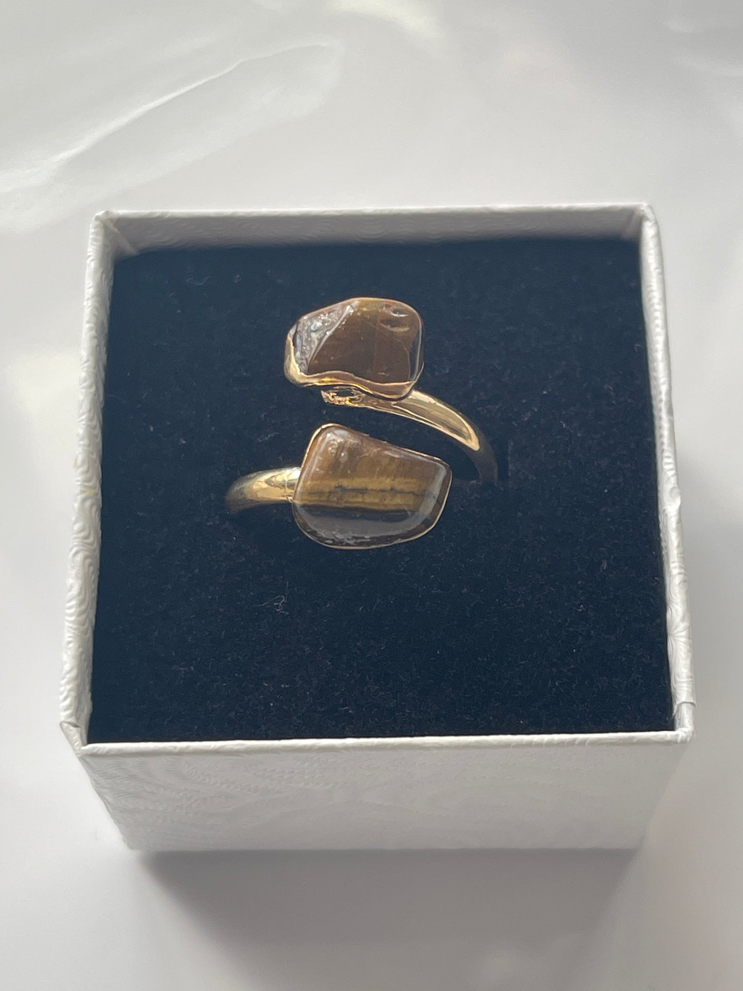 Tigers eye gold plated Ring in a box white jewelry box on a white background in Florida 