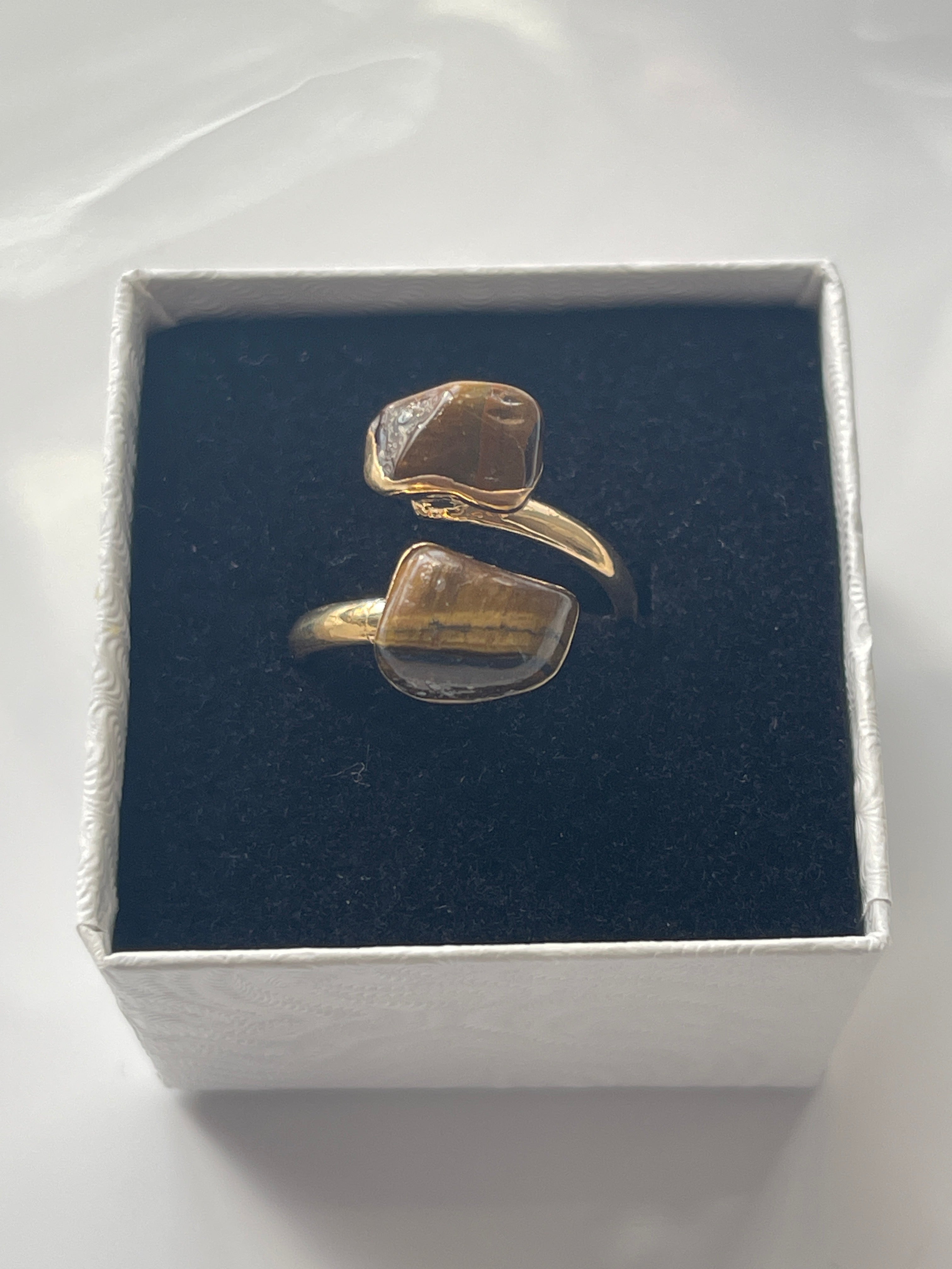 Tigers eye gold plated Ring in a box white jewelry box on a white background in Florida 