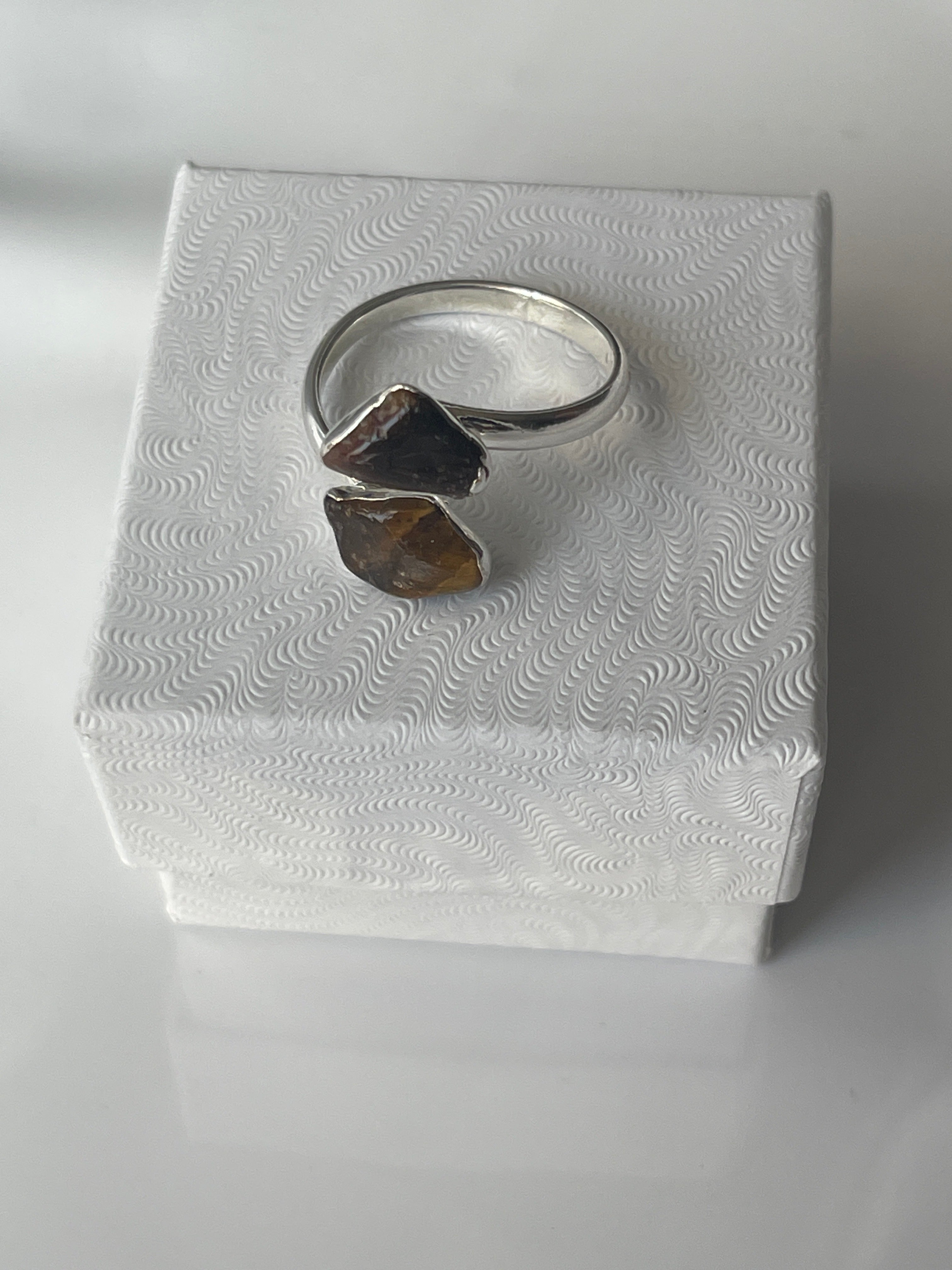 Tigers eye silver plated ring on a textured white jewelry box in Florida 