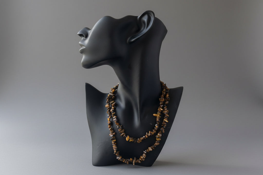 Black jewelry display with Tigers_Eye_Chip_Necklace_30-32_Inches on a gray studio background 
