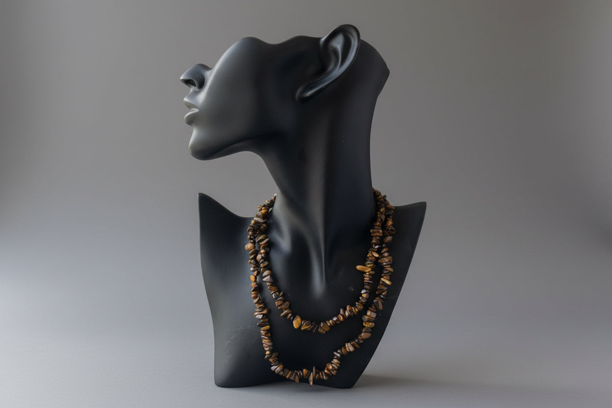 Black jewelry display with Tigers_Eye_Chip_Necklace_30-32_Inches on a gray studio background 