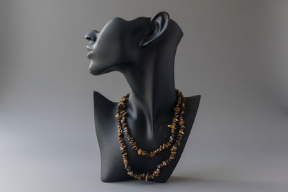 Black jewelry display with Tigers_Eye_Chip_Necklace_30-32_Inches on a gray studio background 