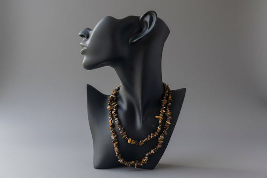 Black jewelry display with Tigers_Eye_Chip_Necklace_30-32_Inches on a gray studio background 