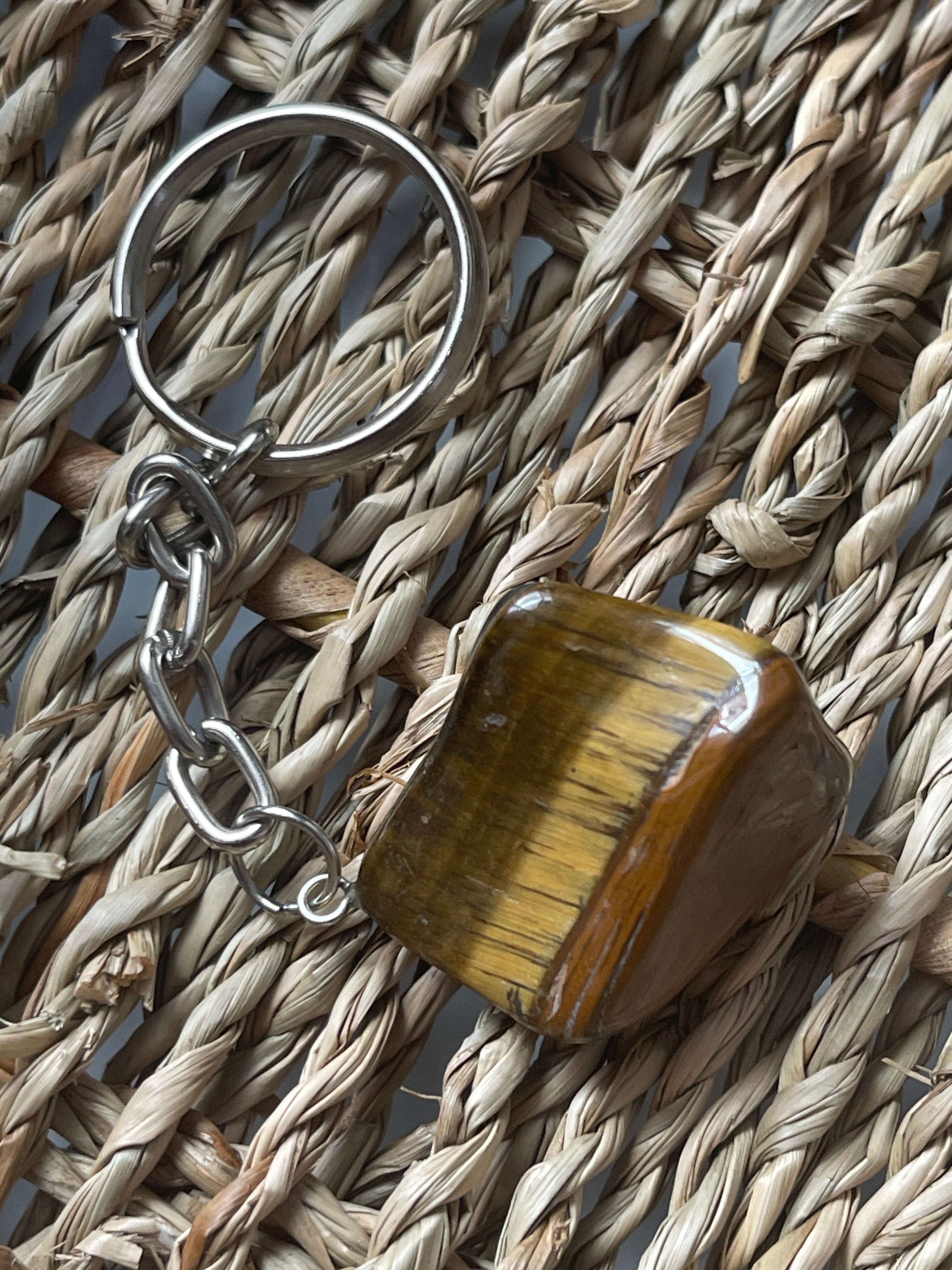 Tiger's eye keychain on a woven surface