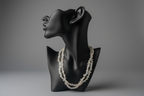 Topaz necklace on a black mannequin bust against a gray background