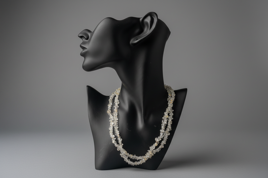 Topaz necklace on a black mannequin bust against a gray background