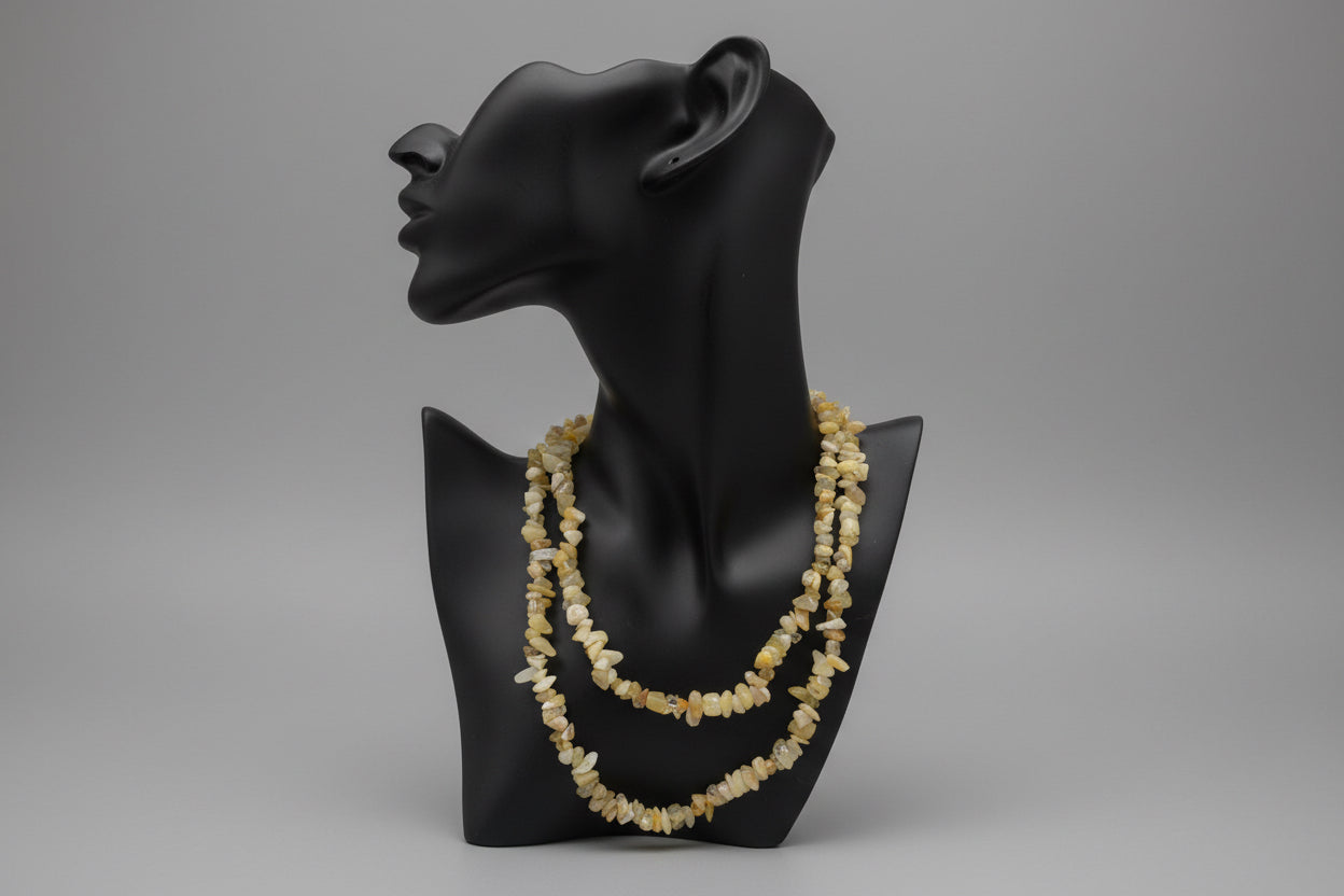Black jewelry holder display with a Yellow_Opal_Necklace_30-32_Inches on a gray backdrop studio surface 