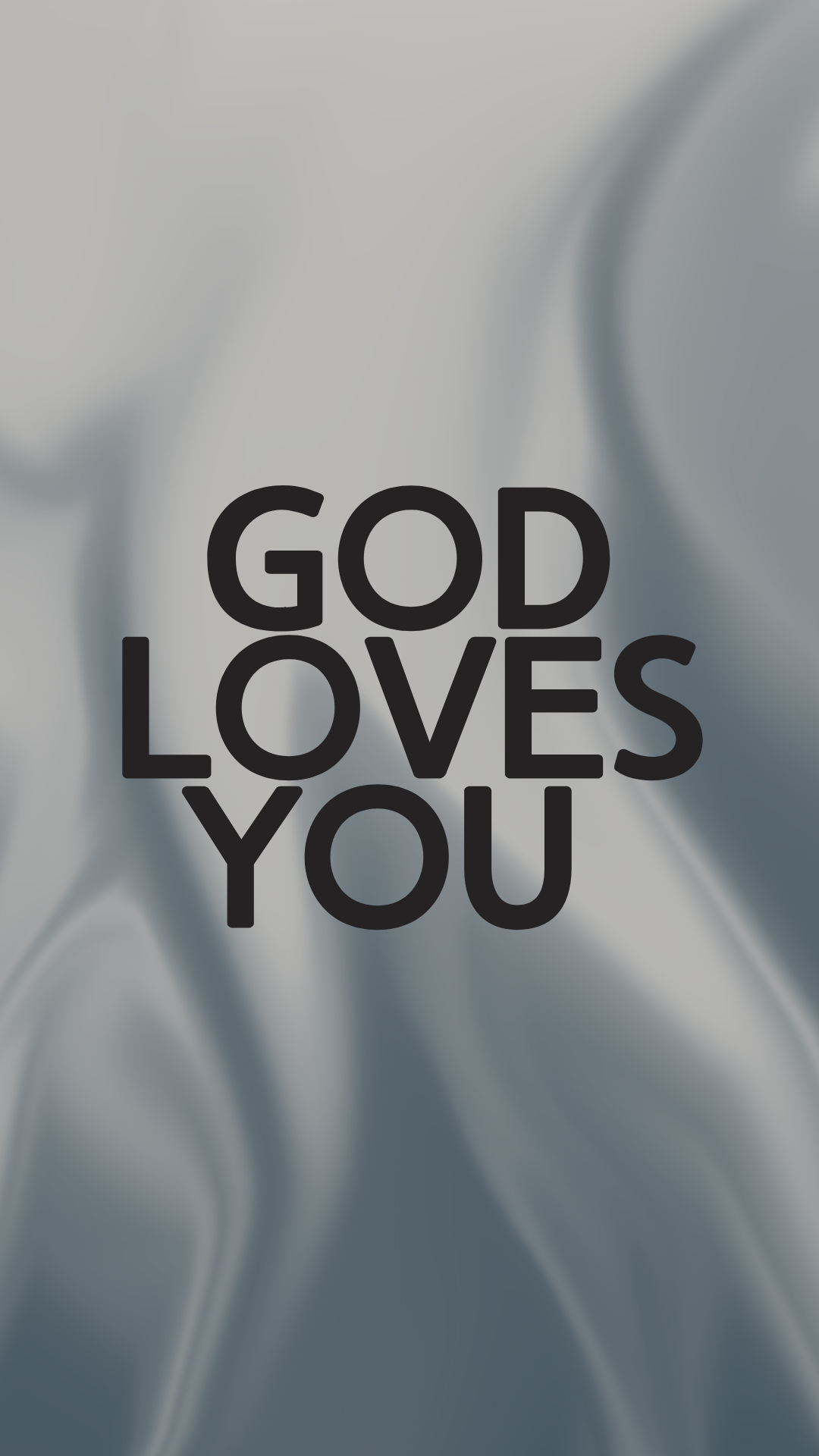 The text 'GOD LOVES YOU' is displayed in large, bold black sans-serif letters centered over a soft gray background with abstract draped fabric-like folds.