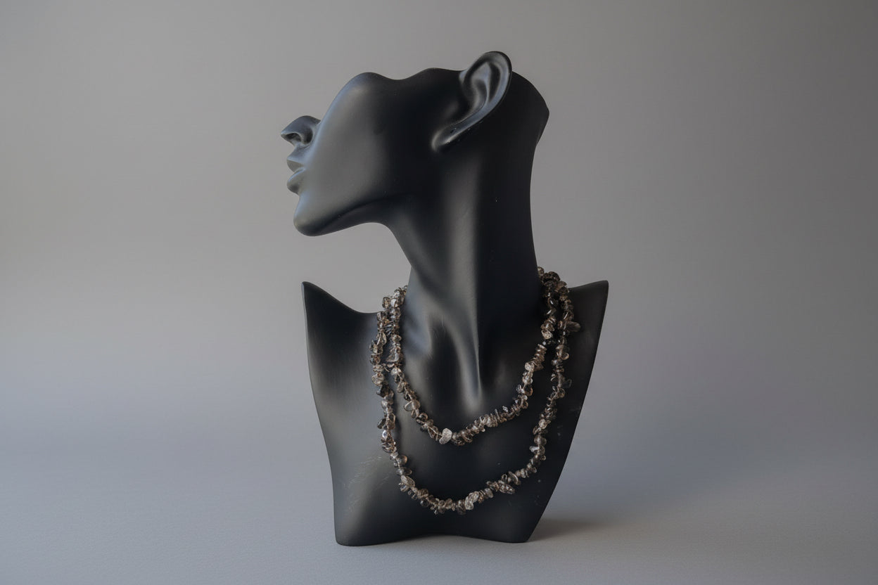 Black jewelry display item with a smoky-quartz-necklaces-30-32-inches on a reflective gray studio backdrop 