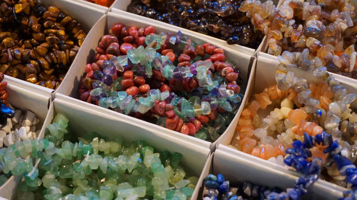 Assorted colorful gemstone  necklaces in compartments